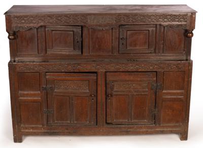 Appraisal: An English oak press cupboard the overhanging cornice carved with