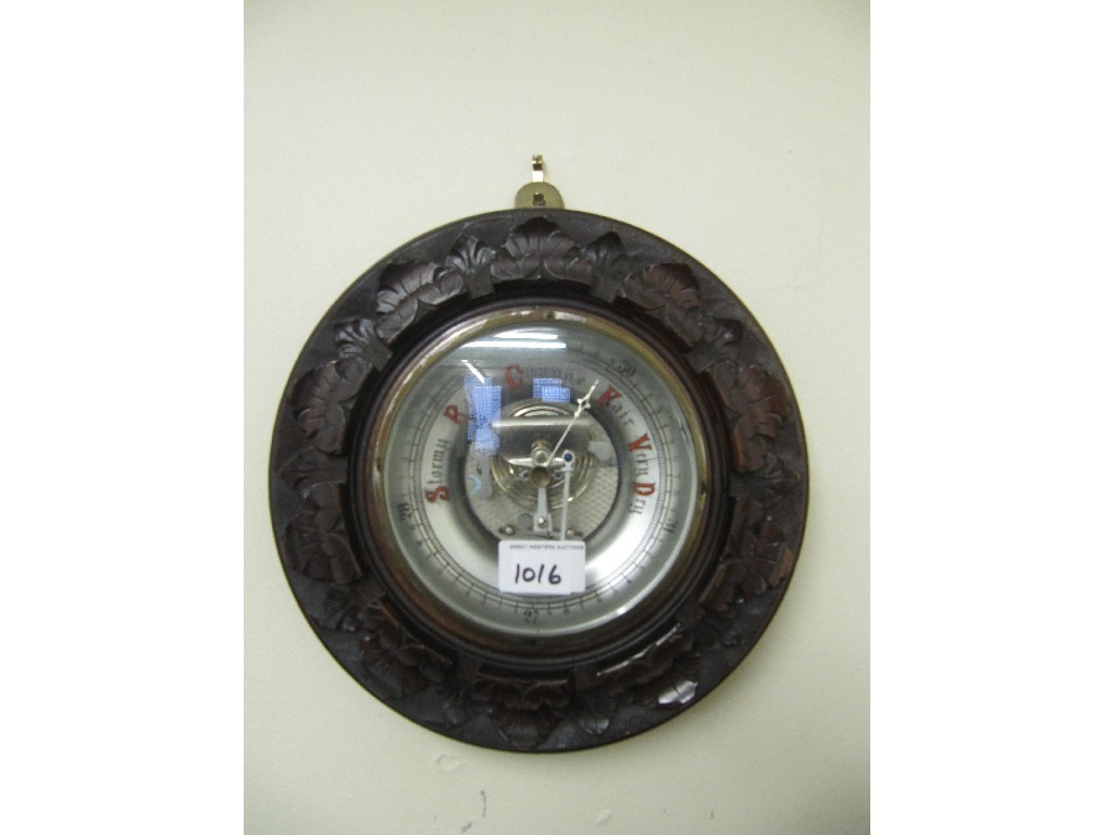 Appraisal: Circular wall barometer in a carved wood frame