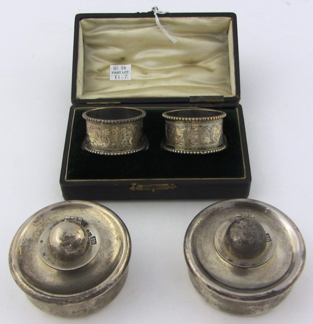 Appraisal: A pair of silver napkin rings with engraved decoration within