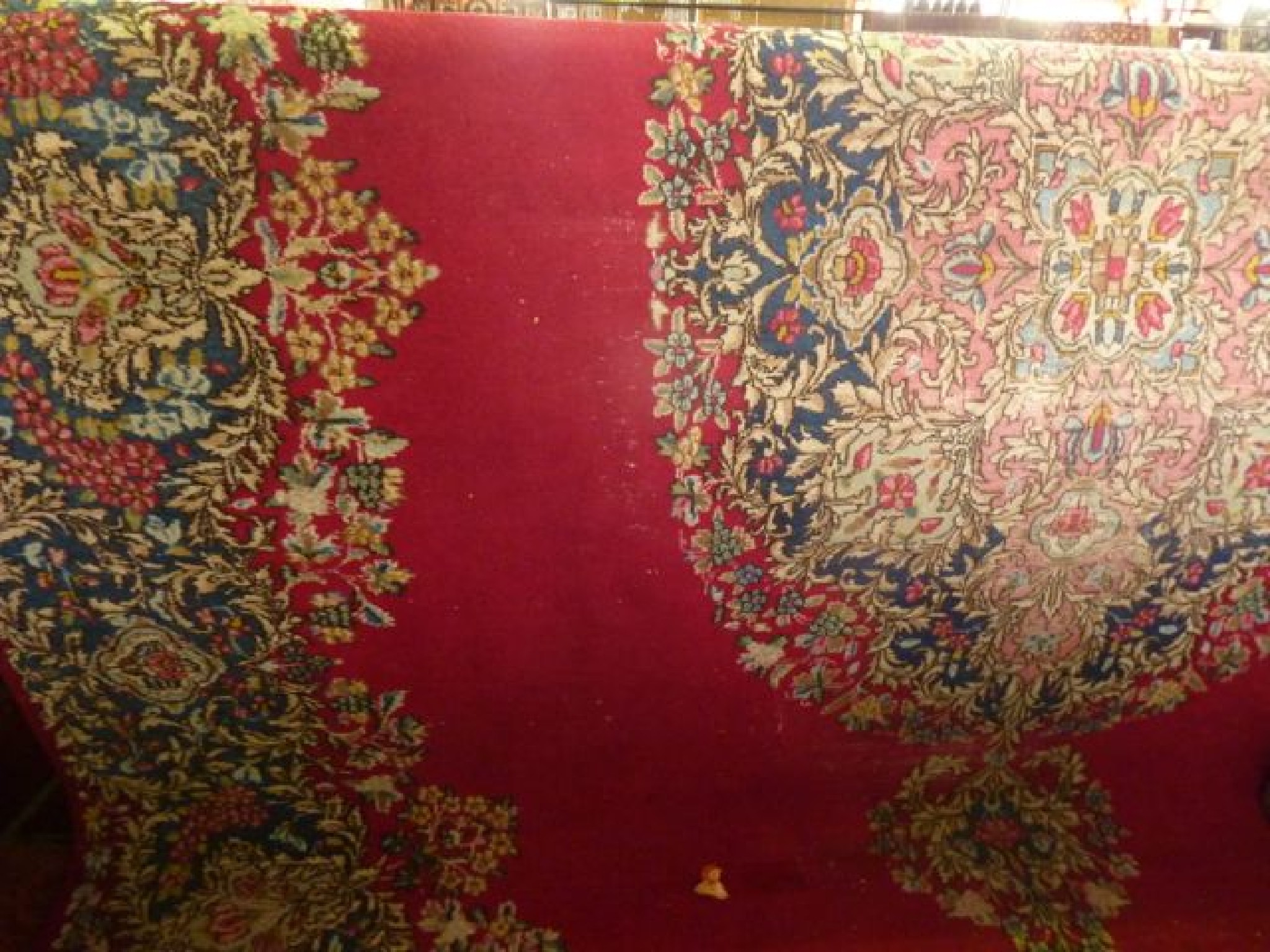 Appraisal: A Persian red ground carpet the central medallion and scrolling