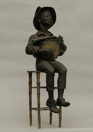 Appraisal: Pot Metal Figure of a Boy Playing a Banjo