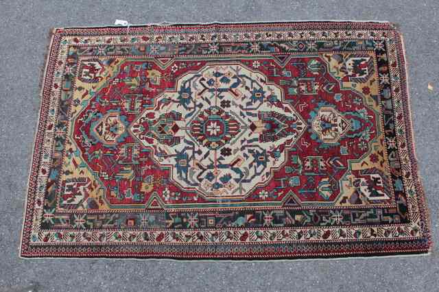 Appraisal: A CAUCASIAN SHIRVAN RUST GROUND RUG of a central white