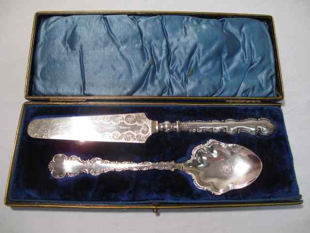 Appraisal: Elaborate spoon and cake server Both are silver plate in