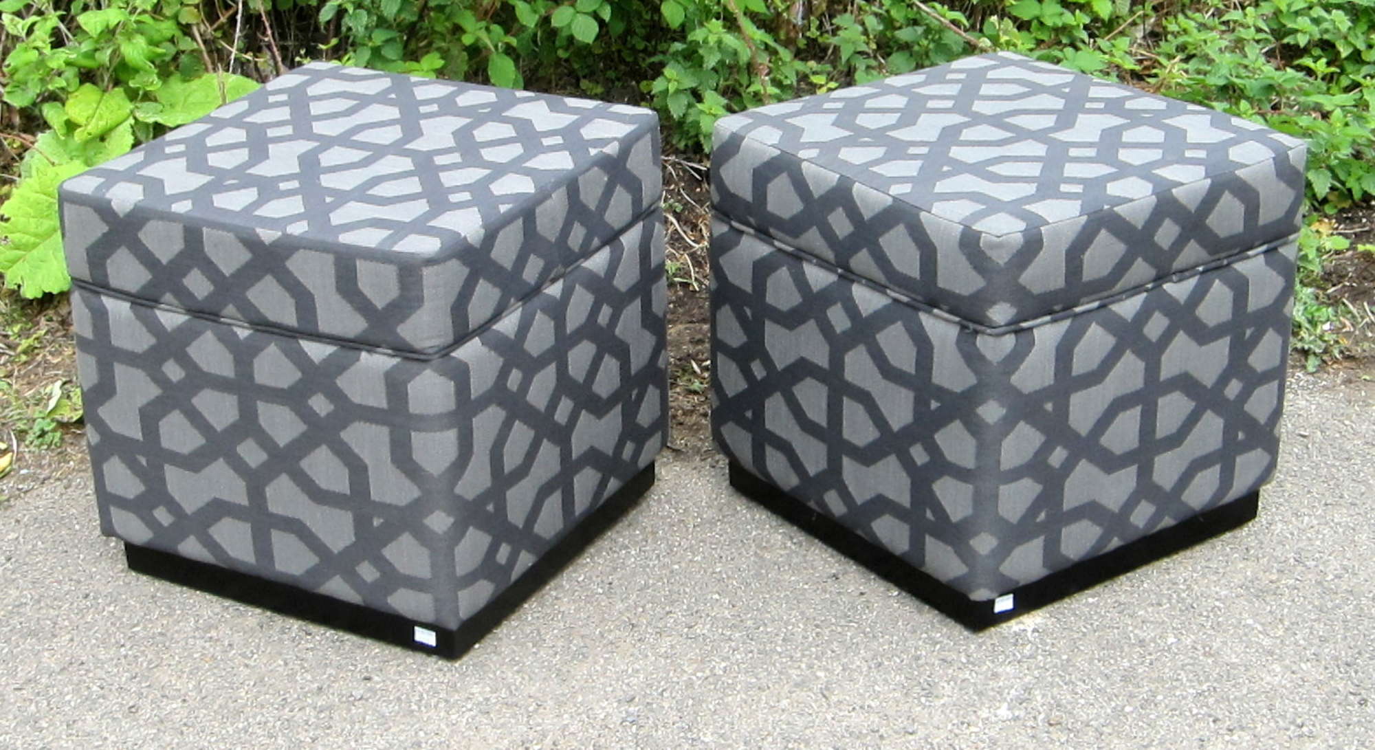 Appraisal: Two cube shaped grey upholstered footstools each with stylised fabric