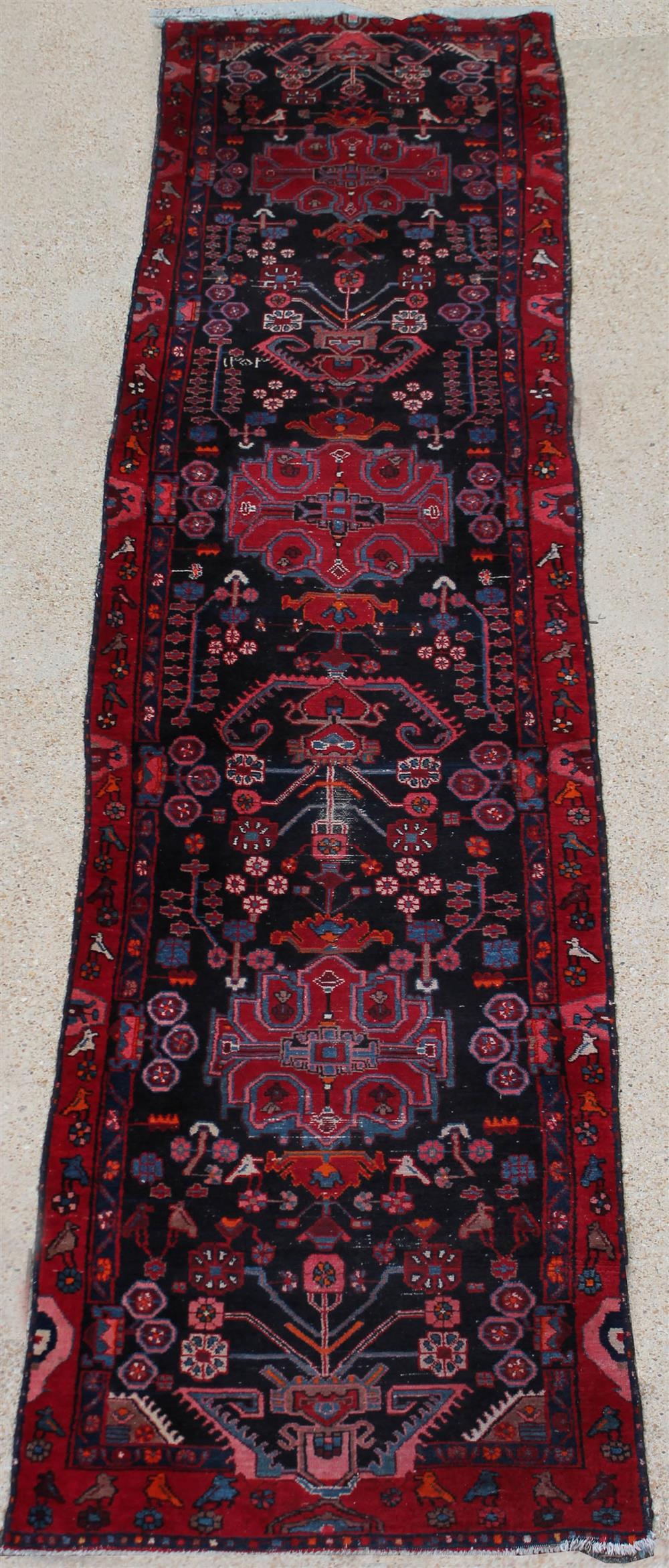 Appraisal: CAUCASIAN WOOL RUNNER with floral and bird motifs having red