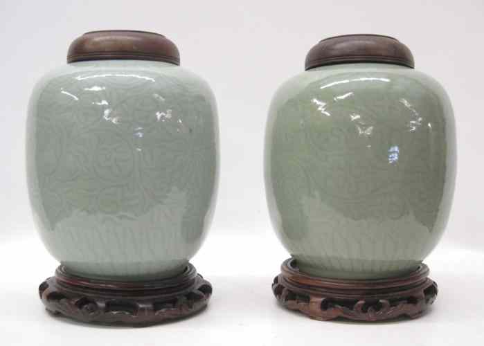 Appraisal: PAIR CHINESE CELADON PORCELAIN GINGER JARS with carved hardwood plinths