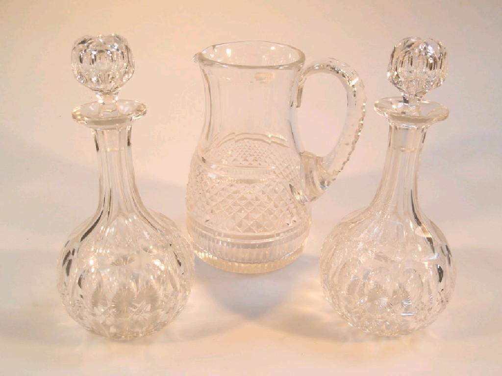 Appraisal: A pair of slice cut glass decanters and a cut