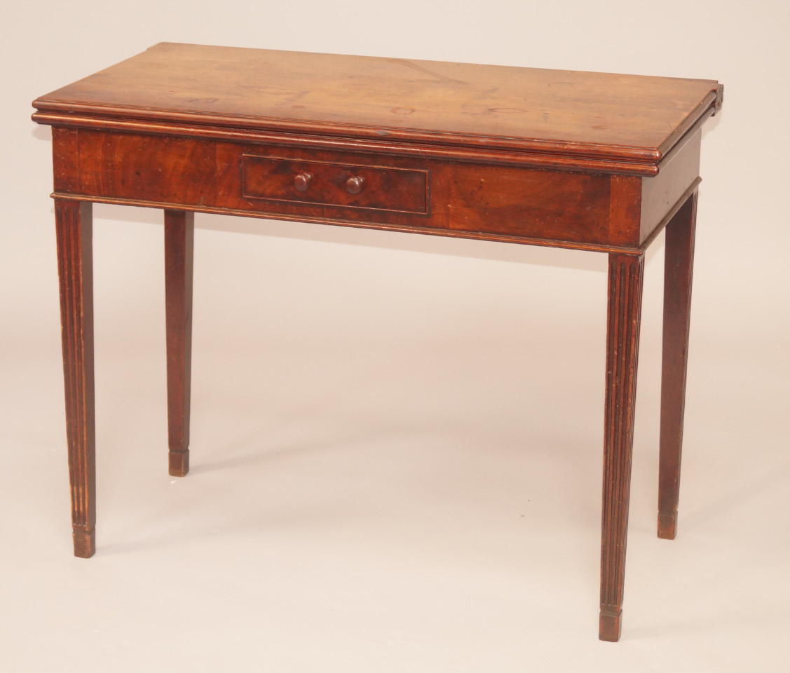 Appraisal: A George III mahogany tea table with rectangular top moulded