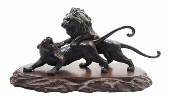 Appraisal: A Japanese Bronze Model of a Lion Attacking a Tiger