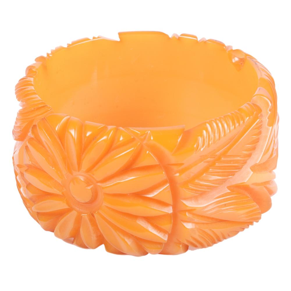 Appraisal: TANGERINE BAKELITE BANGLE BRACELET WITH SUNFLOWER DOUBLE LEAF DESIGN H