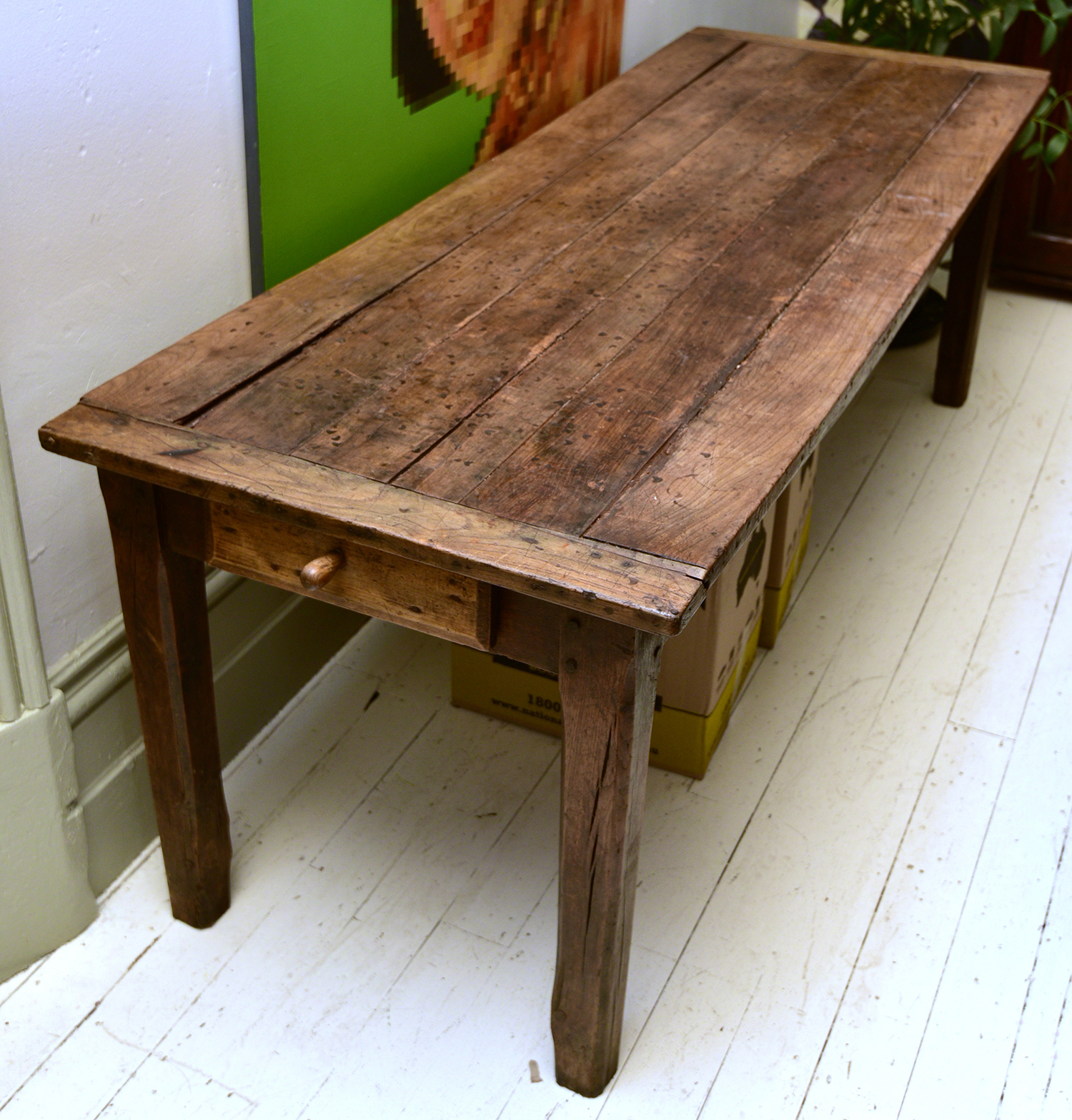 Appraisal: A FRENCH PROVINCIAL PLANK TOP TABLE WITH DRAWERS TO EACH