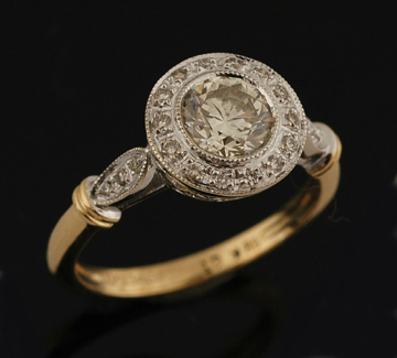 Appraisal: A diamond cluster ring Centrally set with a round brilliant