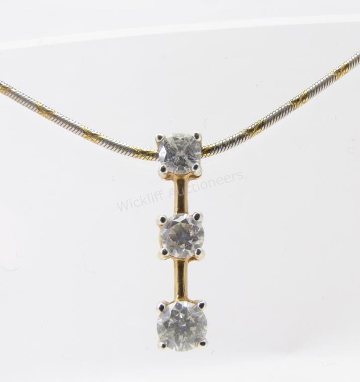 Appraisal: A K yellow gold drop pendant with three diamonds measuring