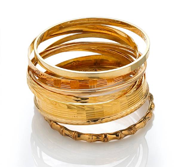 Appraisal: A collection of eleven eighteen and fourteen karat gold bangles