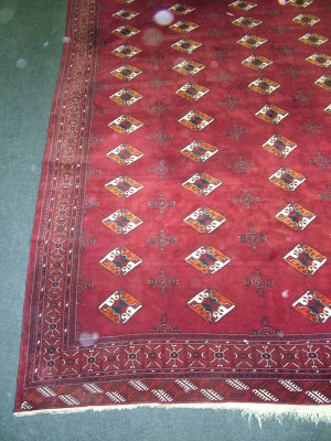 Appraisal: A Tekke design carpet with five rows of small lozenge