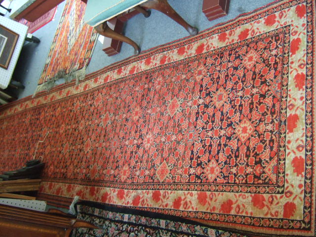 Appraisal: A North West Persian long rug with a red herati