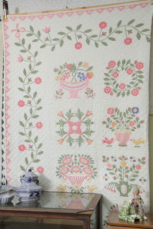 Appraisal: CROSS STITCH QUILT With a floral vine border floral wreath