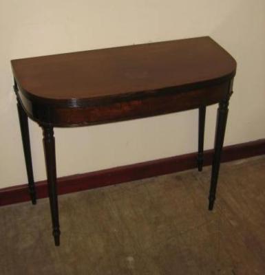 Appraisal: A MAHOGANY FOLDING TEA TABLE of rounded oblong form with