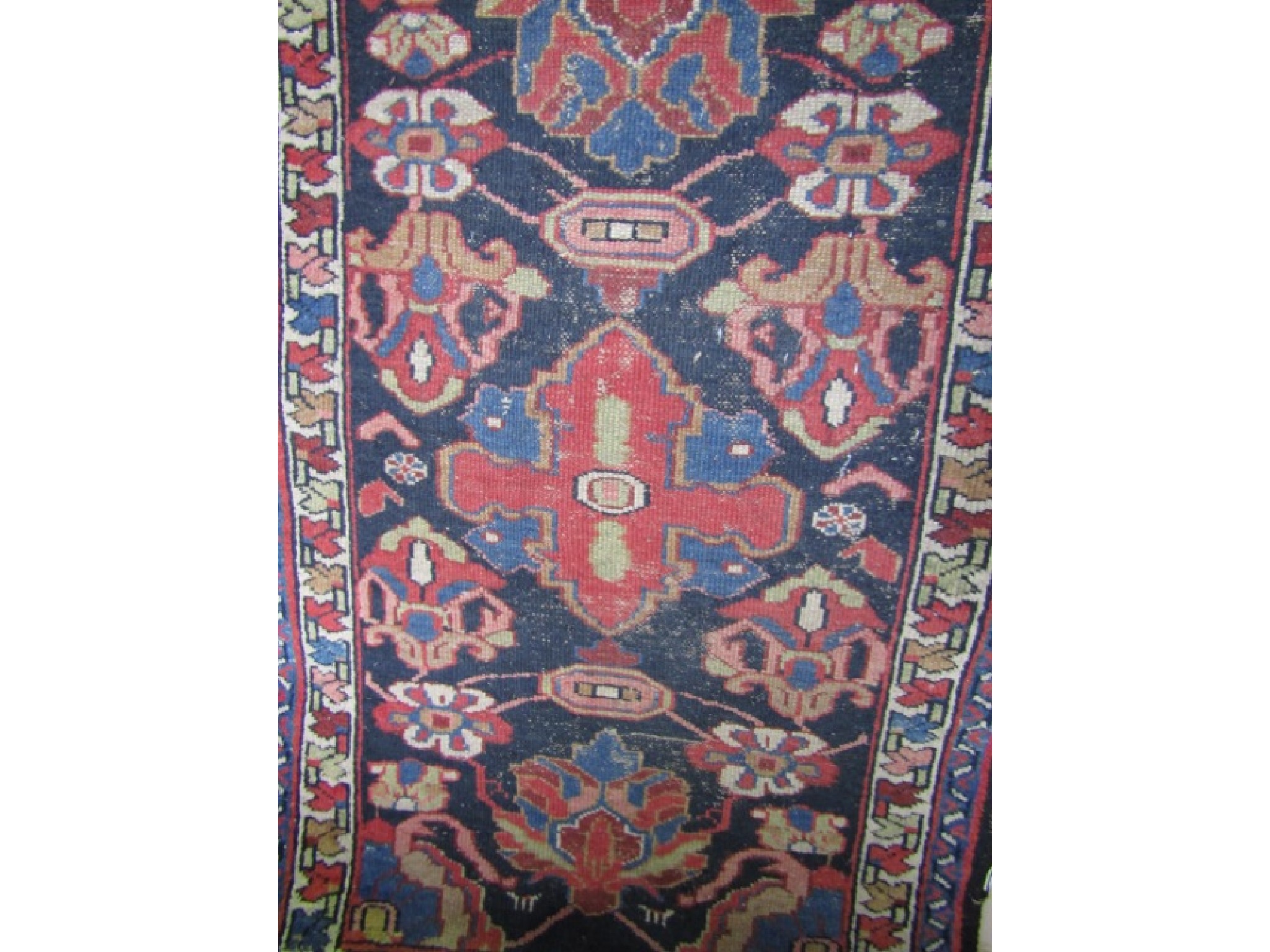 Appraisal: A small eastern wool work rug with dark blue field