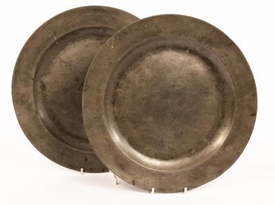 Appraisal: A pair of pewter chargers with folded rims both initialled