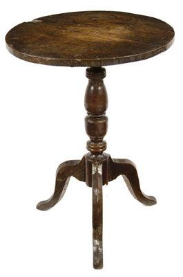 Appraisal: A George III oak tripod table the circular tilt-top on