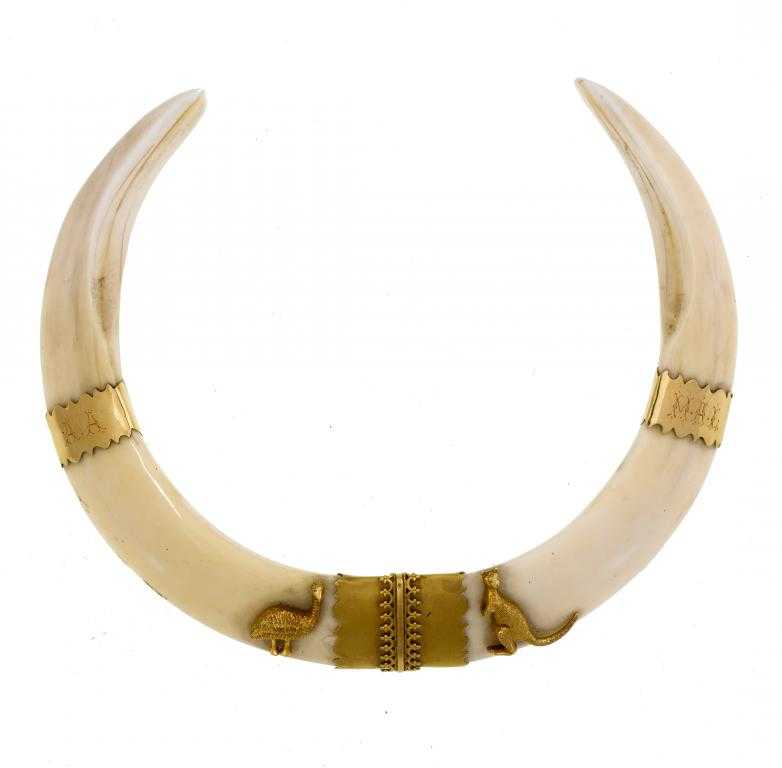 Appraisal: AN AUSTRALIAN GOLD-MOUNTED BOAR TUSK COLLAR applied with an emu