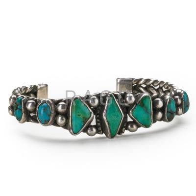 Appraisal: NAVAJO SILVER AND TURQUOISE BRACELET Thick twisted wire bands supporting