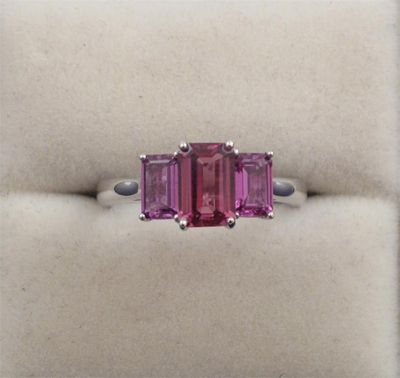 Appraisal: A dark pink sapphire three stone ring The three emerald