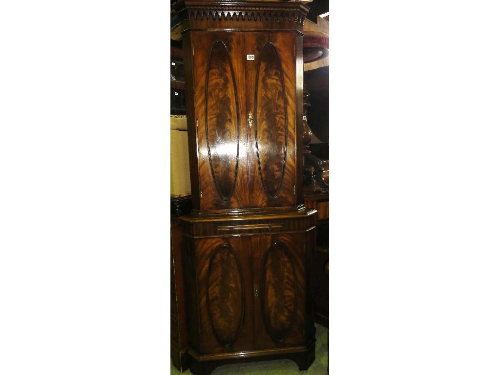 Appraisal: A reproduction Georgian style freestanding mahogany corner cupboard enclosed by