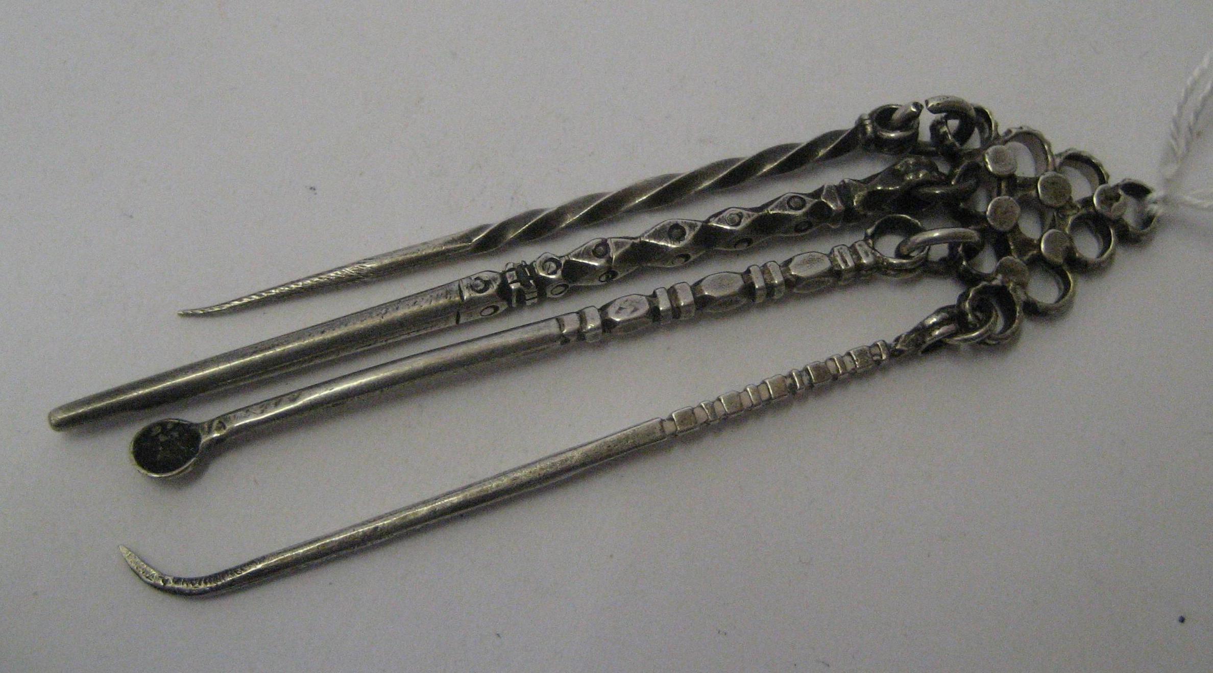 Appraisal: TWO GEORGIAN WHITE METAL TOOTHPICKS unmarked pendant from an open