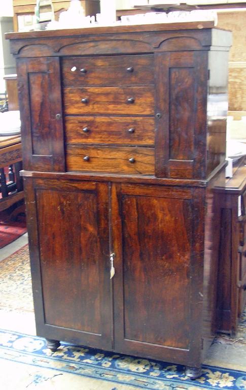 Appraisal: A th century rosewood cabinet fitted doors below and cupboards