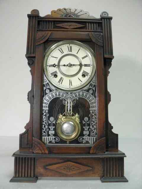 Appraisal: th century carved wood gingerbread clock Pendulum has brass grape