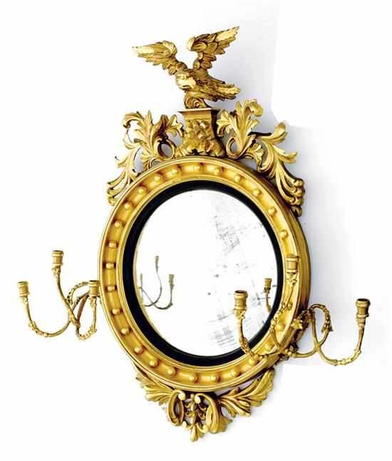 Appraisal: Regency style carved giltwood convex girandole mirror th century spread-wing