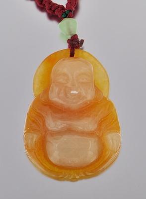 Appraisal: A Carved Jadeite Buddha Pendant Carved jadeite depicting seated Buddha