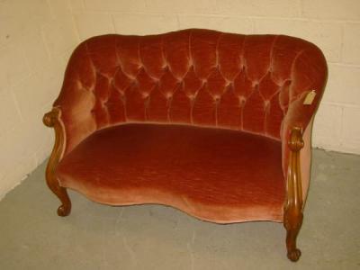 Appraisal: A VICTORIAN WALNUT FRAMED SOFA of serpentine outline button upholstered