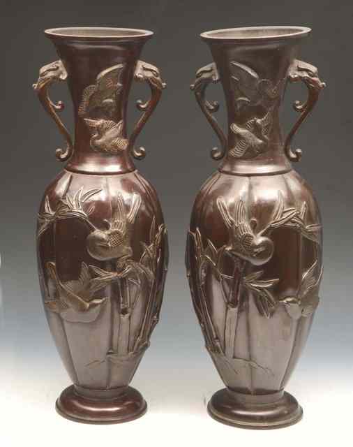 Appraisal: A PAIR OF JAPANESE BRONZE TALL BALUSTER VASES with reeded