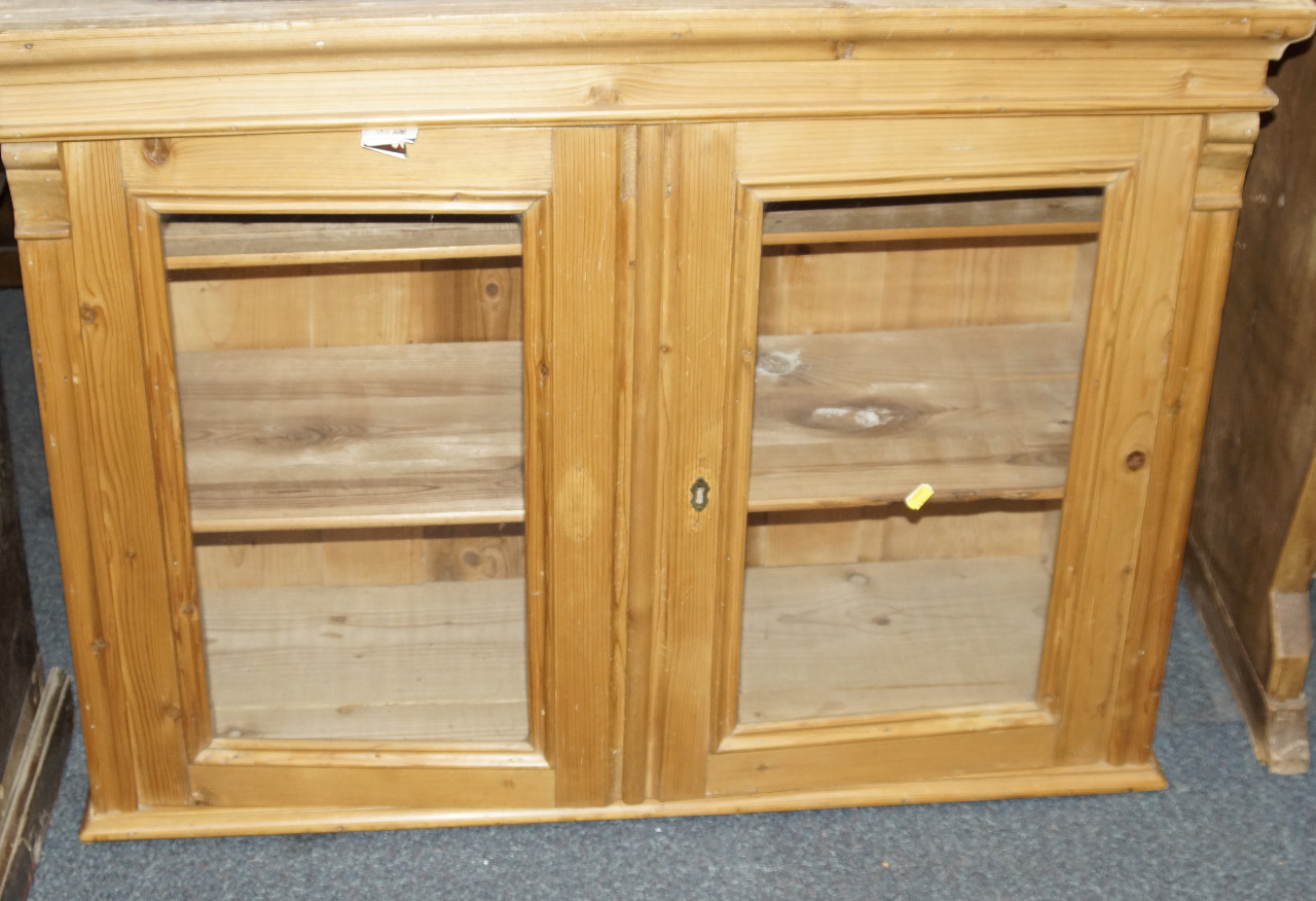 Appraisal: A Victorian pine cabinet with moulded cornice and enclosed by