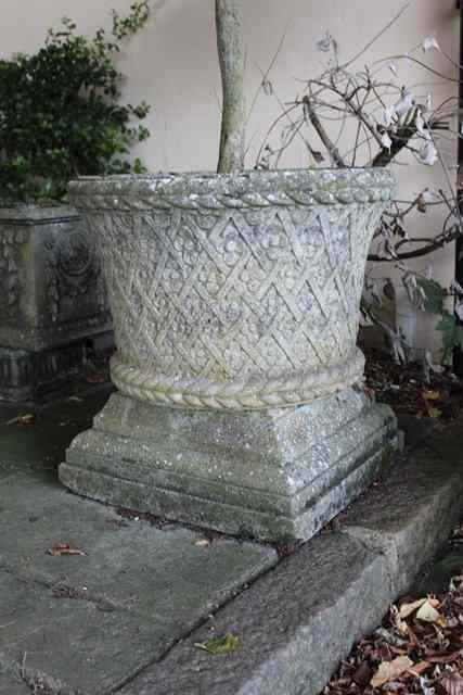 Appraisal: A PAIR OF HADDONSTONE CIRCULAR PLANTERS with basket weave flower