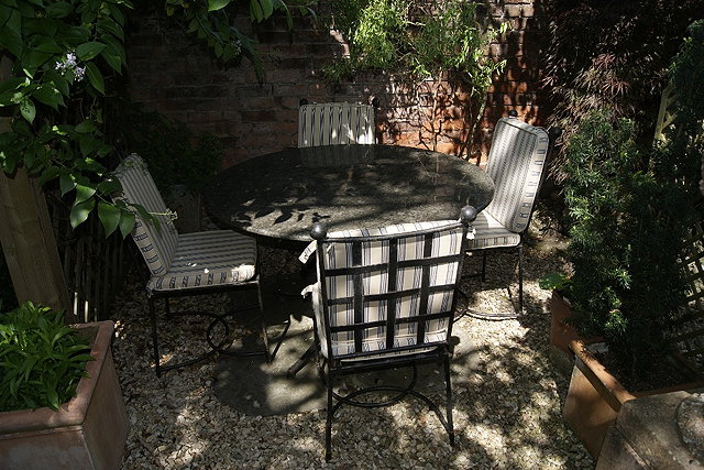 Appraisal: Garden setto include a composite marble top table cm and