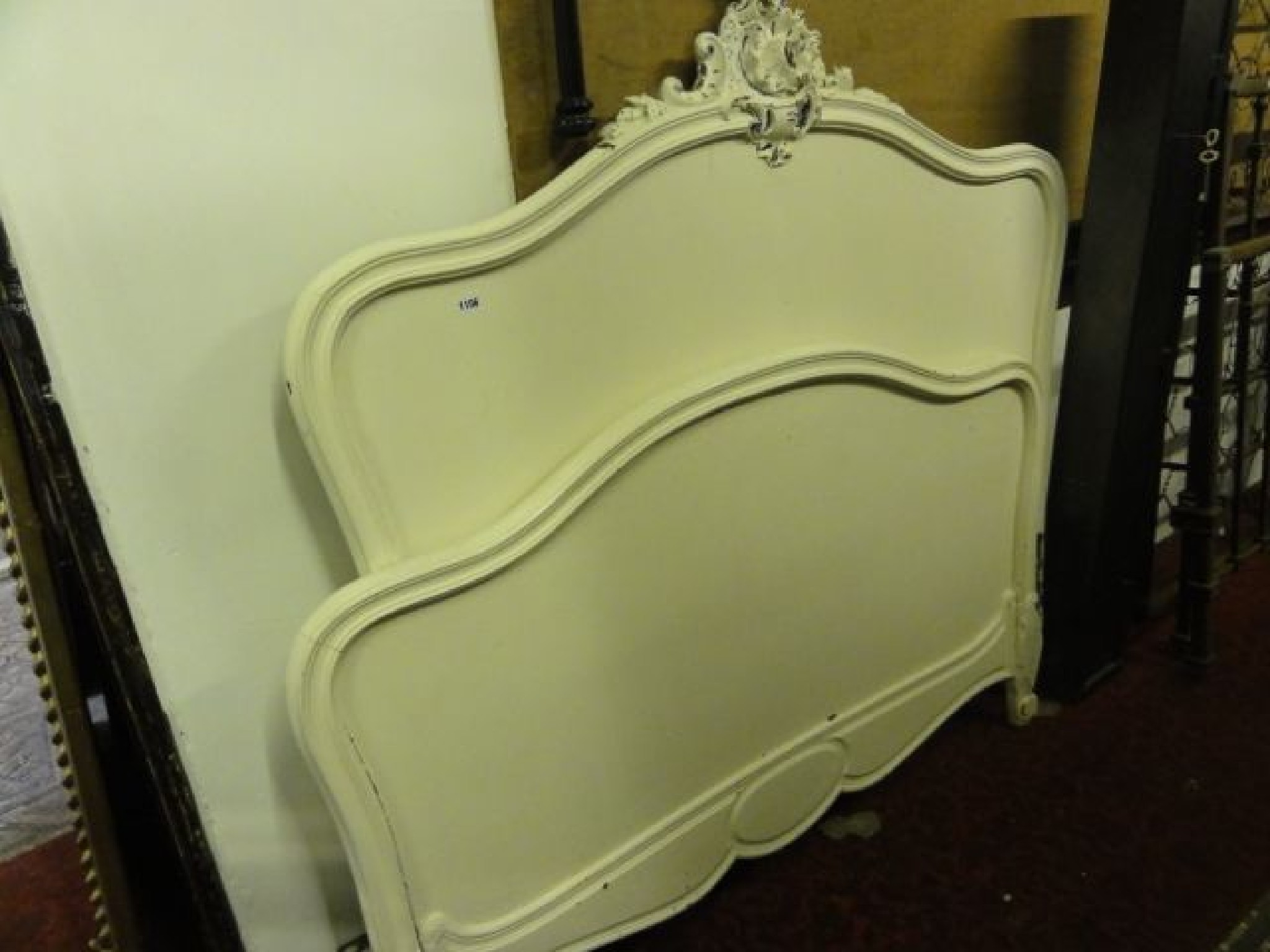 Appraisal: A continental wooden double bedstead with later painted finish the