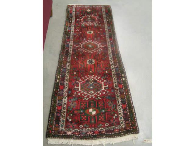 Appraisal: Heriz Persian Handmade Rug geometric medallions red field deep pile