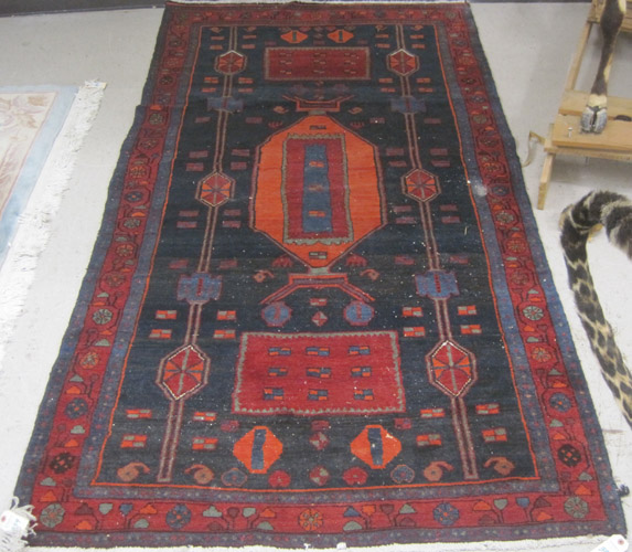 Appraisal: PERSIAN TRIBAL AREA RUG hand knotted in geometric and geometric