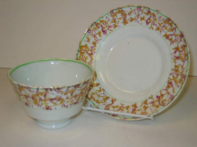 Appraisal: ENGLISH SPATTERWARE Yellow and purple spatter handless cup and saucer