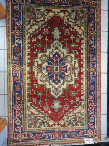 Appraisal: Heriz Persian Handmade Rug central medallion floral borders red field