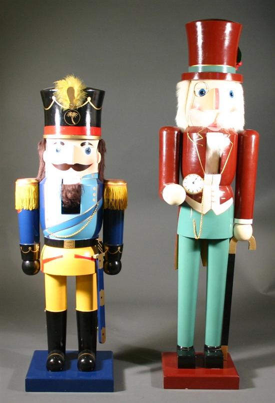 Appraisal: Two modern nutcrackers A gentleman nutcracker in burgundy jacked with