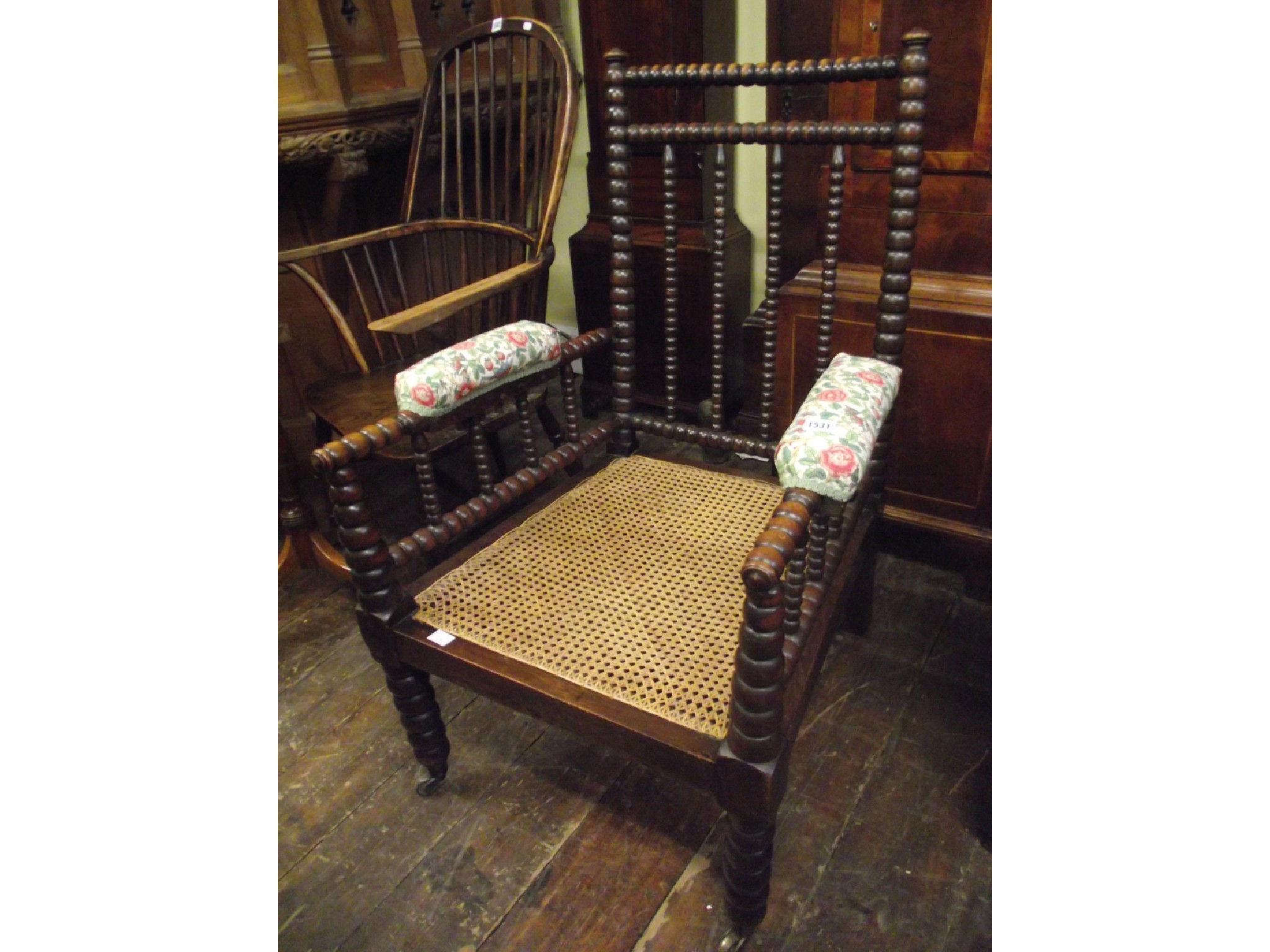 Appraisal: An Arts Crafts bobbin moulded elbow chair with cane panelled