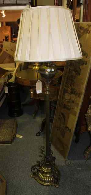 Appraisal: A VICTORIAN BRASS AND IRON STANDARD LAMP with adjustable column