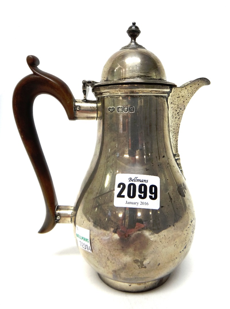 Appraisal: A silver hot water jug of baluster form in the