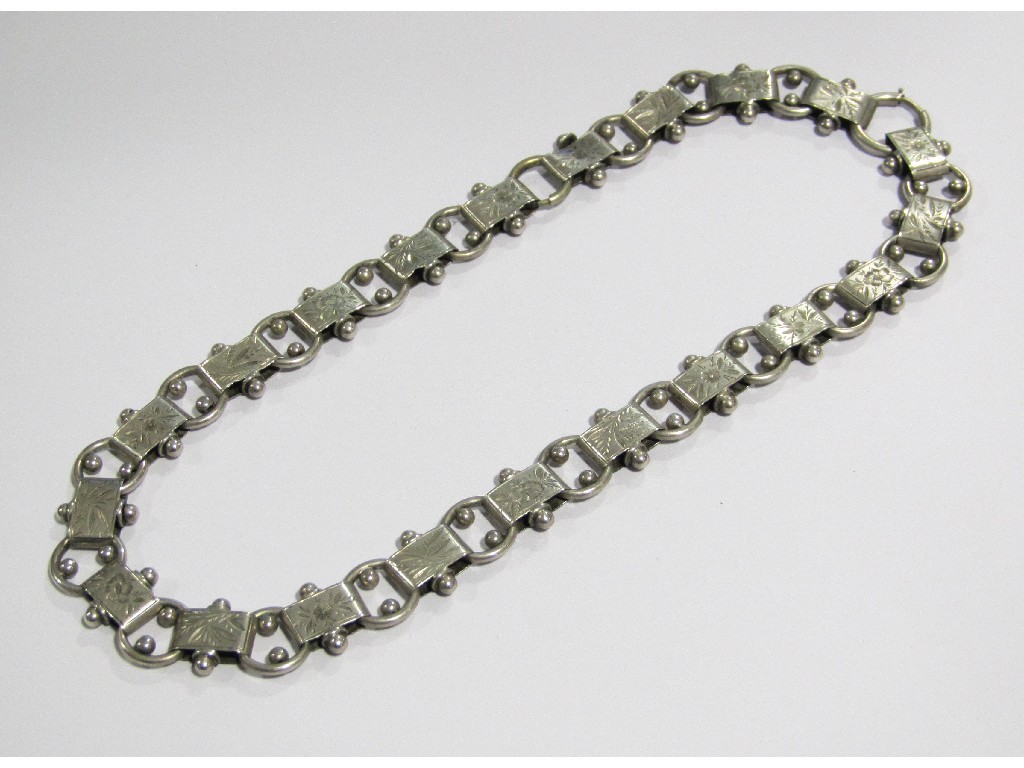 Appraisal: A Victorian silver collar with engraved foliate sections linked by