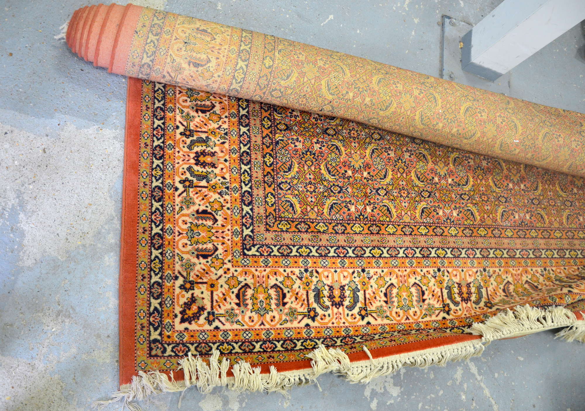 Appraisal: Machine made red ground rug